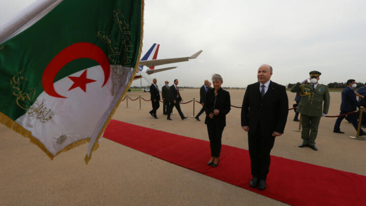 French Prime Minister Elisabeth Borne, left, is welcomed by Algerian Prime Minister Aimene Benabderrahmane as she arrives in Algiers, October 9, 2022, to begin a two-day visit to Algeria.